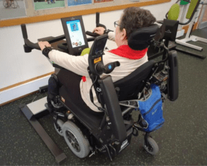 Woman in wheelchair using HUR Optimal Rhomb machine